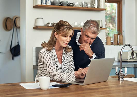 A couple using a laptop computer in their home