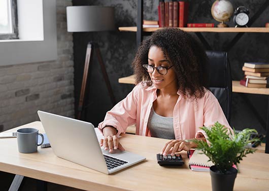 Young lady in an office using a laptop computer