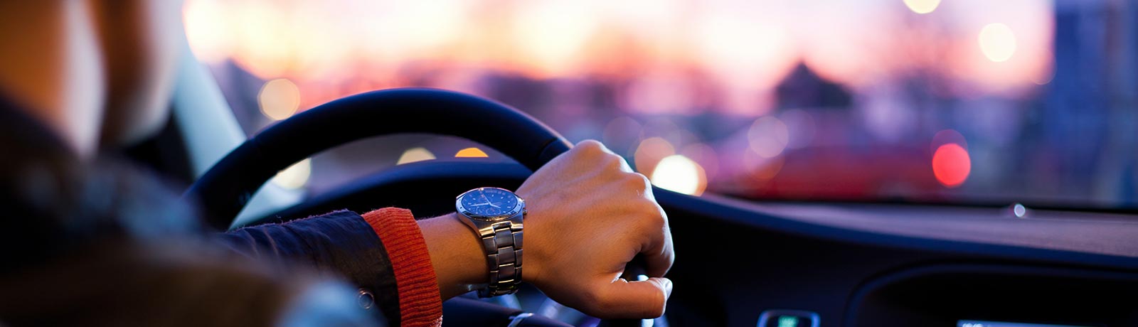 A man driving a new car